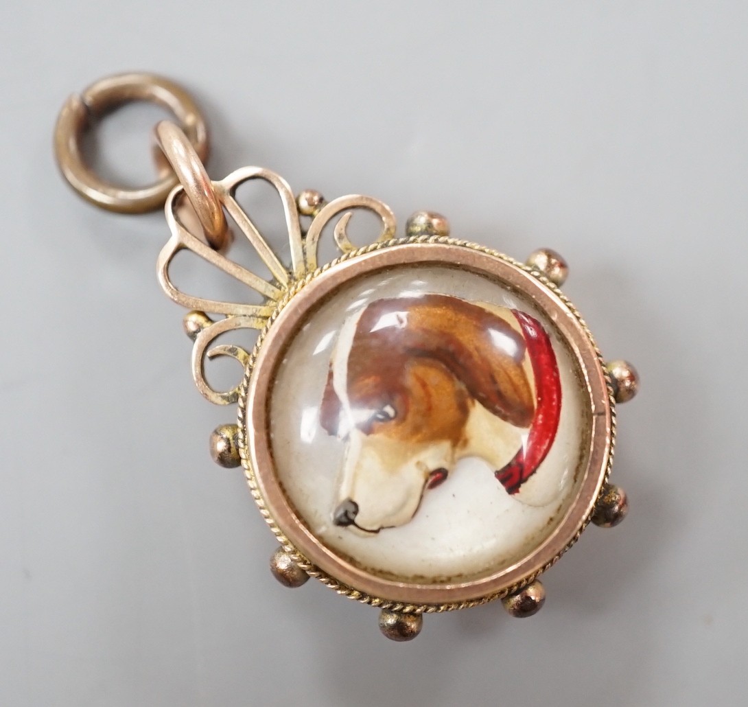 A late Victorian 9ct gold mounted Essex crystal and compass set fob, 25mm, the crystal decorated with the head of a dog.